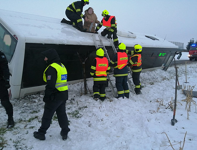 Hasiči evakuovali lidi z převráceného autobusu, vytáhli je střešním oknem