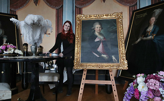 Průvodkyně kunínského zámku Natálie Minarčíková stojí u obrazů představitelů...