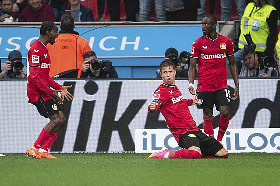 Útoník Adam Hloek z Leverkusenu se svými spoluhrái slaví vstelený gól.