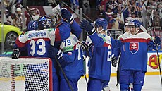 PRVNÍ VÝHRA. Sloventí hokejisté objímají gólmana Stanislava korvánka po...