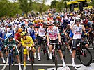 Cyklisté na startu druhé etapy Tour de France s driteli jednotlivých dres v...