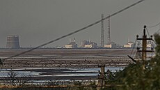 Záporožská jaderná elektrárna za řekou Dněpr. Vodní překážka se po zničení...