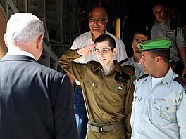 Voják Gilad alit po svém proputní salutuje izraelskému premiérovi Benjaminu...