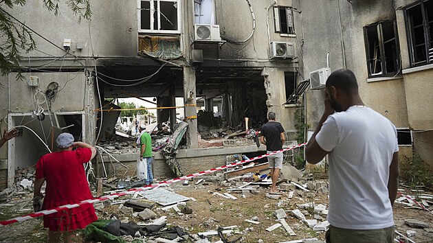 V izraelskm Akelonu kontroluj pokozenou obytnou budovu po zsahu raketou vyplenou z psma Gazy. (9. jna 2023)