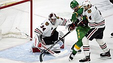 Branká� Petr Mrázek z Chicaga zasahuje v utkání proti Minnesot�.