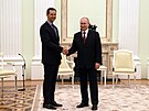Ruský prezident Vladimir Putin si potásá rukou se syrským prezidentem Baárem...