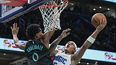 Paolo Banchero (vpravo) z Orlando Magic zakon�uje na ko� Washington Wizards,...