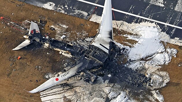 Po nehod na letiti Haneda v Tokiu, kde zaal hoet po srce s jinm menm strojem Airbus A350 spolenosti Japan Airlines, zstaly na ranveji ohoel trosky stroje. (3. ledna 2024)