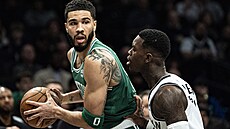 Jayson Tatum (vlevo) z Bostonu brán�ný Dennisem Schröderem z Brooklynu.