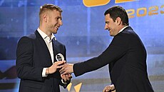 Nejlepí stelec hokejové extraligy Jakub Rychlovský (vlevo) pebírá cenu.