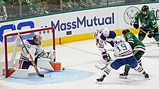 Gólman Edmontonu Stuart Skinner zasahuje proti stele Logana Stankovena z...