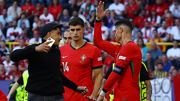 Cristiano Ronaldo, bir hayranını cep telefonuyla reddediyor.