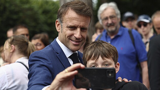 Prezident Macron, kter pedasn volby teprve ped temi tdny pekvapiv vyhlsil, hlasoval v Touqet v departementu Pas-de-Calais, kde jako obvykle dlouze uval pzn davu a s lidmi se objmal a poizoval si selfie. (30. ervna 2024)