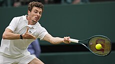 Ugo Humbert se natahuje po míčku v osmifinále Wimbledonu.