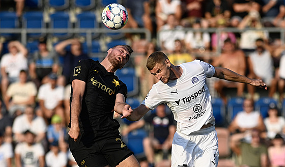 Slávista Tomá� Chorý hlavi�kuje p�ed Filipem Va�kem ze Slovácka.