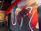 Interiér dopluje street art a projekce, které navrhlo studio By All Means. 