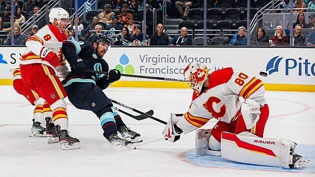 Branká� Dan Vlada� z Calgary Flames zasahuje b�hem zápasu se Seattle Kraken.