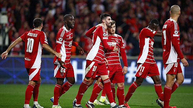 Brest footballers celebrate a goal in Bayer Leverkusen's net.