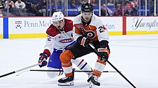 Scott Laughton (21) z Philadelphia Flyers kouzlí s pukem, brání ho Arber Xhekaj...