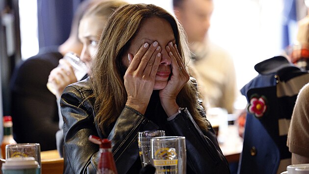P�íznivkyn� Kamaly Harrisové si zakrývá o�i, kdy� se na obrazovce zobrazují...