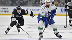 Filip Hronek z Vancouveru rozehrává, za ním spchá Kevin Fiala z Los Angeles.