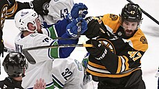 Filip Hronek (vlevo) z Vancouveru a Mark Kastelic z Bostonu v roztr�ce p�ed...