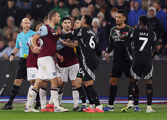 West Hamský Tomá� Sou�ek v poty�ce s fotbalisty Arsenalu.