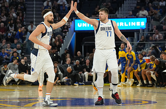 Klay Thompson (vlevo) a Luka Doni z Dallasu oslavují úspnou akci v utkání...