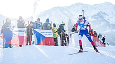 Michal Kr�má� projí�dí okolo �eských fanou�k� p�i sprintu v Hochfilzenu.