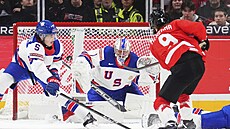 Americký gólman Trey Augustine (1) elí pokusu kanadského juniora Gavina...