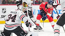 Chicagský branká� Petr Mrázek zasahuje proti st�ele Matthewa Tkachuka z Floridy.