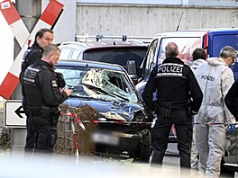 Policisté stojí u pokozeného vozidla v centru nmeckého Mannheimu. (3. bezna...