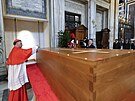 Kardinál Rolandas Makrikas p�ikládá pe�e� na rakev s t�lem zesnulého pape�e...