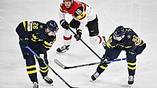 védové Anton Bengtsson (vlevo) a Jesper Frödén drí puk ped Dominikem...