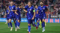 Luka Modri slaví se spoluhrái gól proti esku.