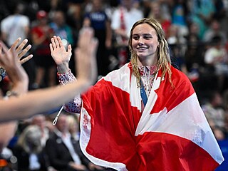 Kanadská plavkyn Summer McIntoshová zdraví fanouky po polohovém závodu na 200...
