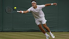 Jakub Meník se natahuje pro míek ve tetím kole Wimbledonu.