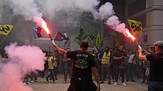 Stávkující zamstnanec eleznic mává svtlicí na paíské sídlo ministerstva...