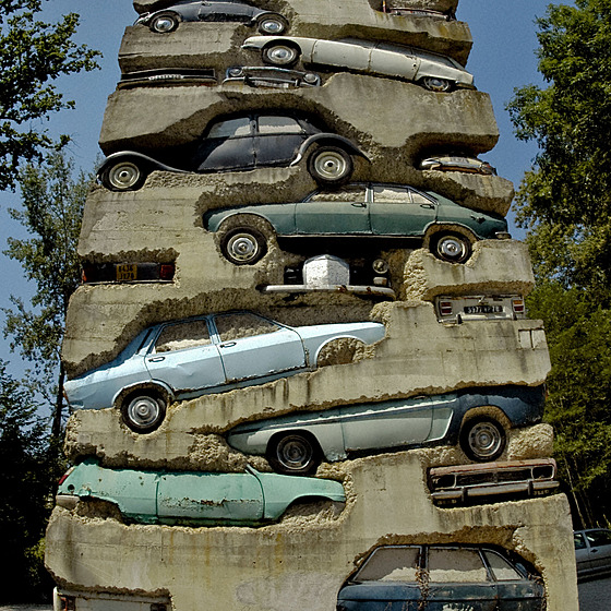 Monolitická skulptura tu neodhaluje ani tak automobily, jako spí emoce divák.