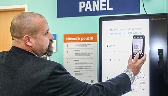 editel FN Brno Ivo Rovný naítá QR kód s navigací do svého mobilního telefonu.