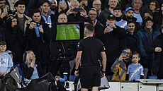 Sudí zkoumá video v zápase Manchester City - Liverpool.
