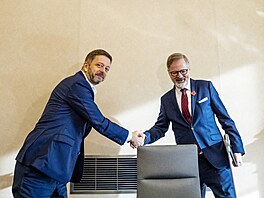 Premiér Petr Fiala a ministr vnitra Vít Raku�an  se zdraví p�ed sch�zi vlády v...