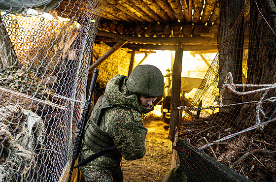 Ruský voják st�ílí z polního d�la na ukrajinské pozice na front� u Kupjansku....