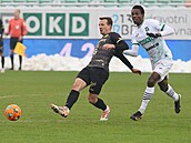 Karvinský útoník Abdallah Gning sleduje pihrávku královehradeckého Vladimíra...