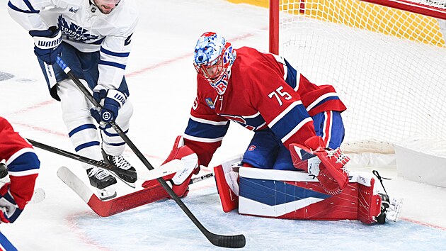 Brank�� Montrealu Jakub Dobe� zasahuje proti �anci Scotta Laughtona z Toronta.