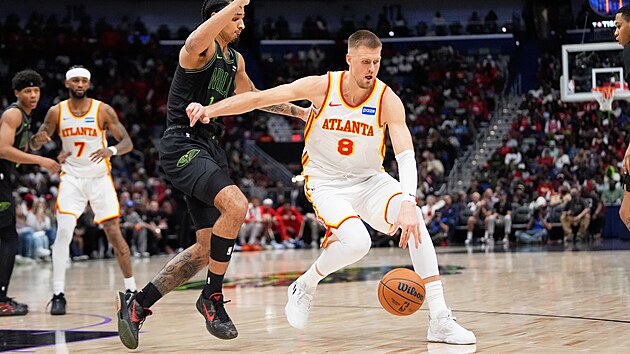 Kristaps Porzingis (vpravo) z Atlanty se sna�� prodrat kolem Micaha Peavyho z...