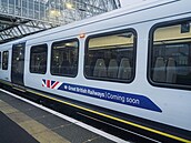 Vlak s reklamou poutající na nové barvy britské eleznice na nádraí Waterloo...