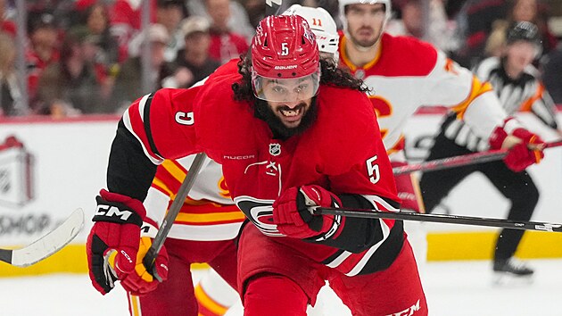 Jalen Chatfield (5) z Carolina Hurricanes se ��t� za pukem.