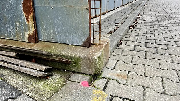 Vietnamsk� tr�nice v H�ensku. P��stavek mus� z chodn�ku pry�. Prostor mezi zd� a r��ov�m punt�kem na zemi je toti� pozemek obce. (prosinec 2025)