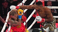 Jake Paul se brání úder�m, kterými ho �astuje boxer Anthony Joshua.